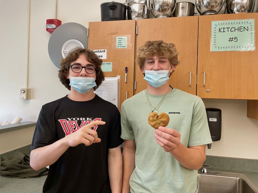 C IS FOR COOKIE: Sophomores Lucas Smith and Devon Sullivan pose with a heart-shaped cookie to show their C-LUV. Smith and Sullivan completed the Cookie Lab on the 28th. They were especially proud of their heart-shaped sweet. 