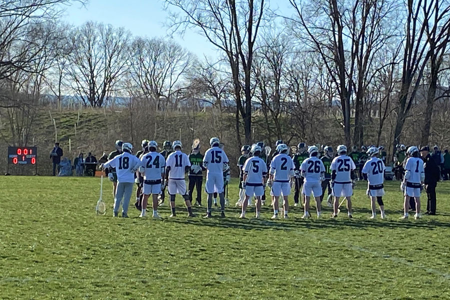 HEAD IN THE GAME: Carlisle boys lacrosse gets ready to face off against Central Dauphin. The starting line up is pictured before the game having a discussion with the other team and the officials.