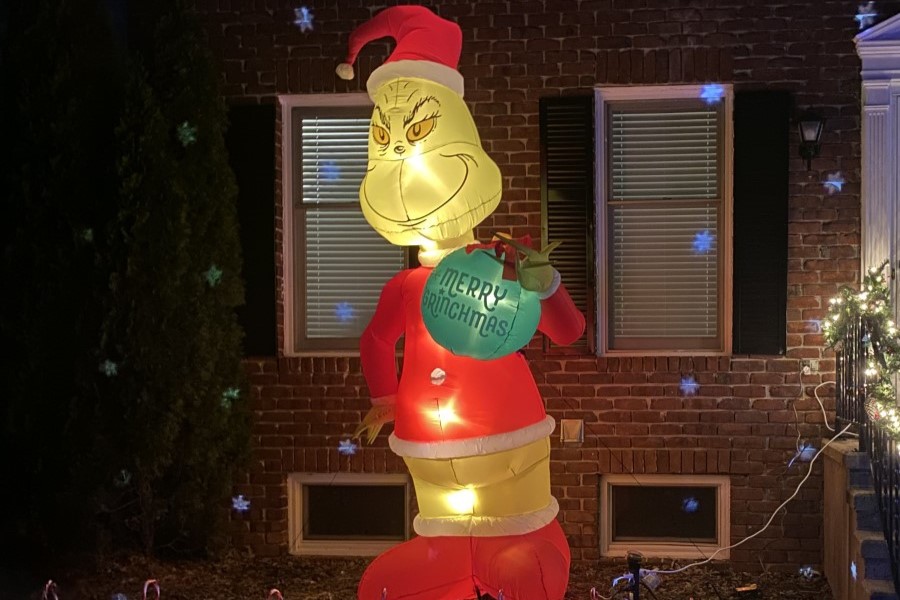 HOW THE GRINCH STOLE CHRISTMAS: A Grinch blowup outside of a house decorated for Christmas.