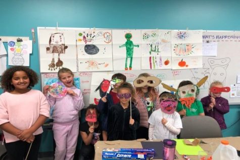 ARTS IN: This photo is from a previous Schools Out, Arts In program where they had made a variety of animal masks. Along with their drawings of various animals hung up behind them.