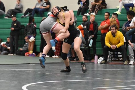 FOR THE WIN: Coldren is pictured taking down her opponent during a girls wrestling match this season. 