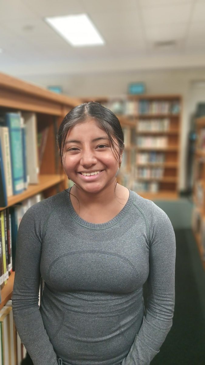 Olivia Pavlovich (senior) studies in the library. When asked to rate her excitement for the Taylor Swift Eras Tour movie, she replied, "It's a 10/10, I'm excited and terrified that people are going to treat it like a concert. But I'm totally gonna dress up!"