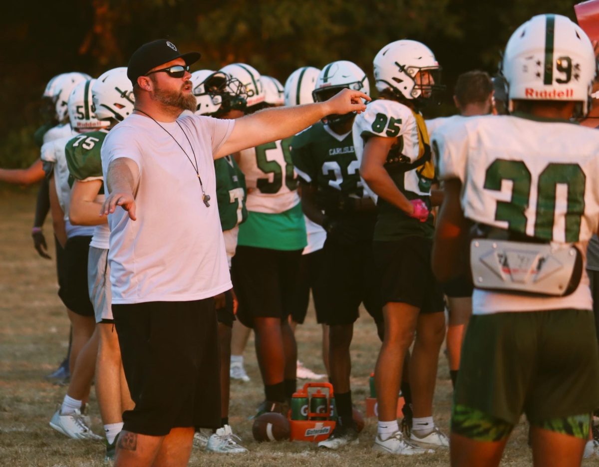 Coach Cook guides the players into position during practice on Wednesday, September 6. 