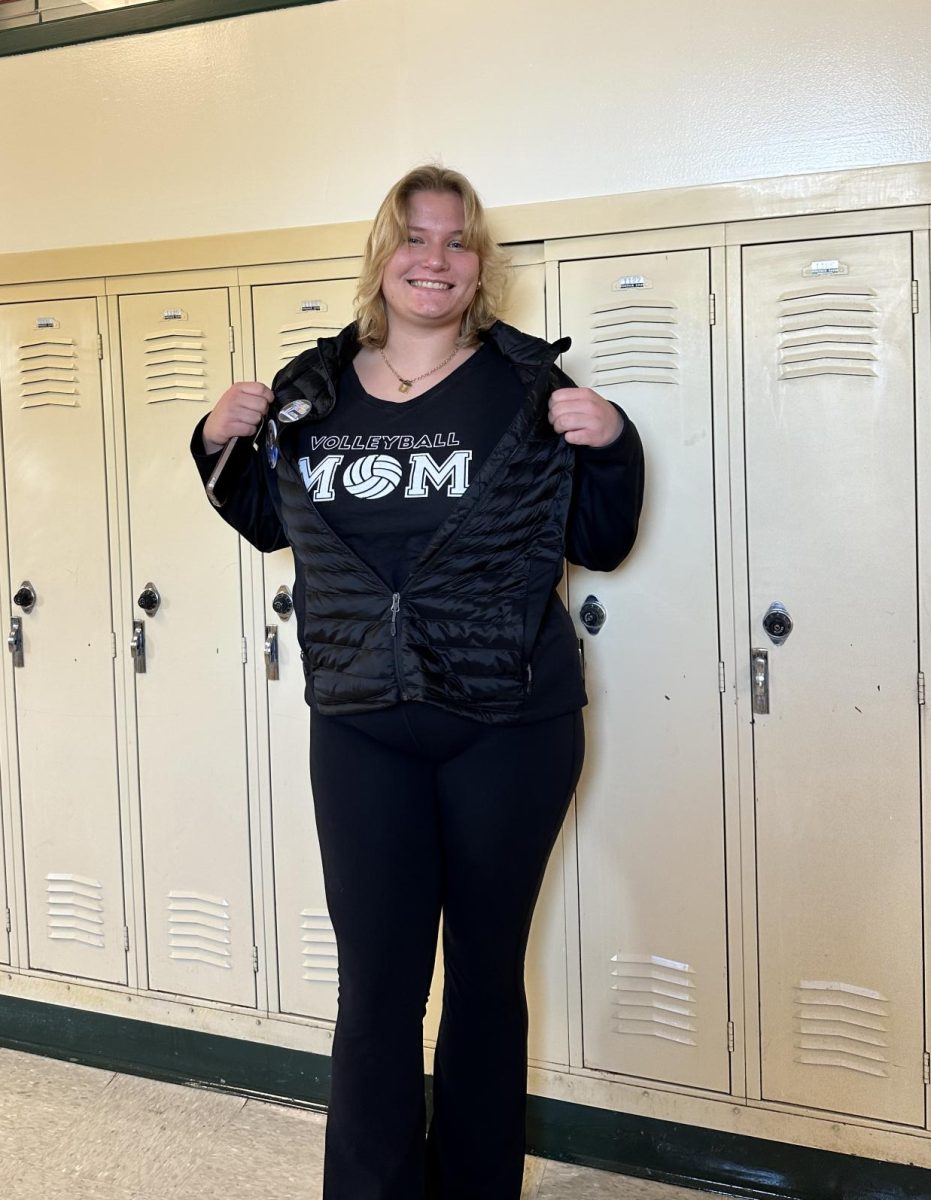 Senior Emily Sheffe represents her long line of "soccer moms" with a vest adorned with her own sports pins from her career!