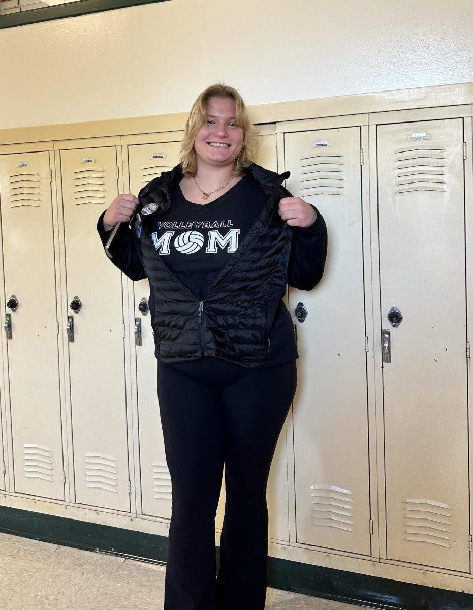 Senior Emily Sheffe represents her long line of soccer moms with a vest adorned with her own sports pins from her career!