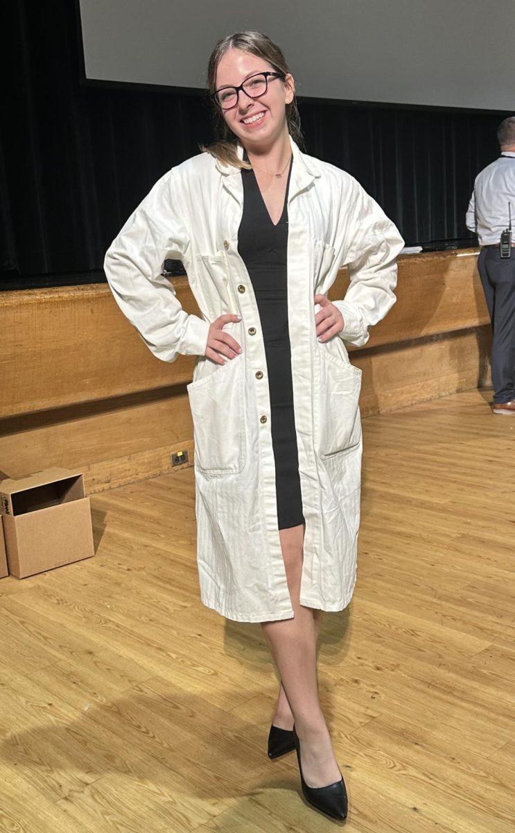 Woman in STEM: Senior Selah Nieratko wears a lab coat and heels displaying her love of science! 