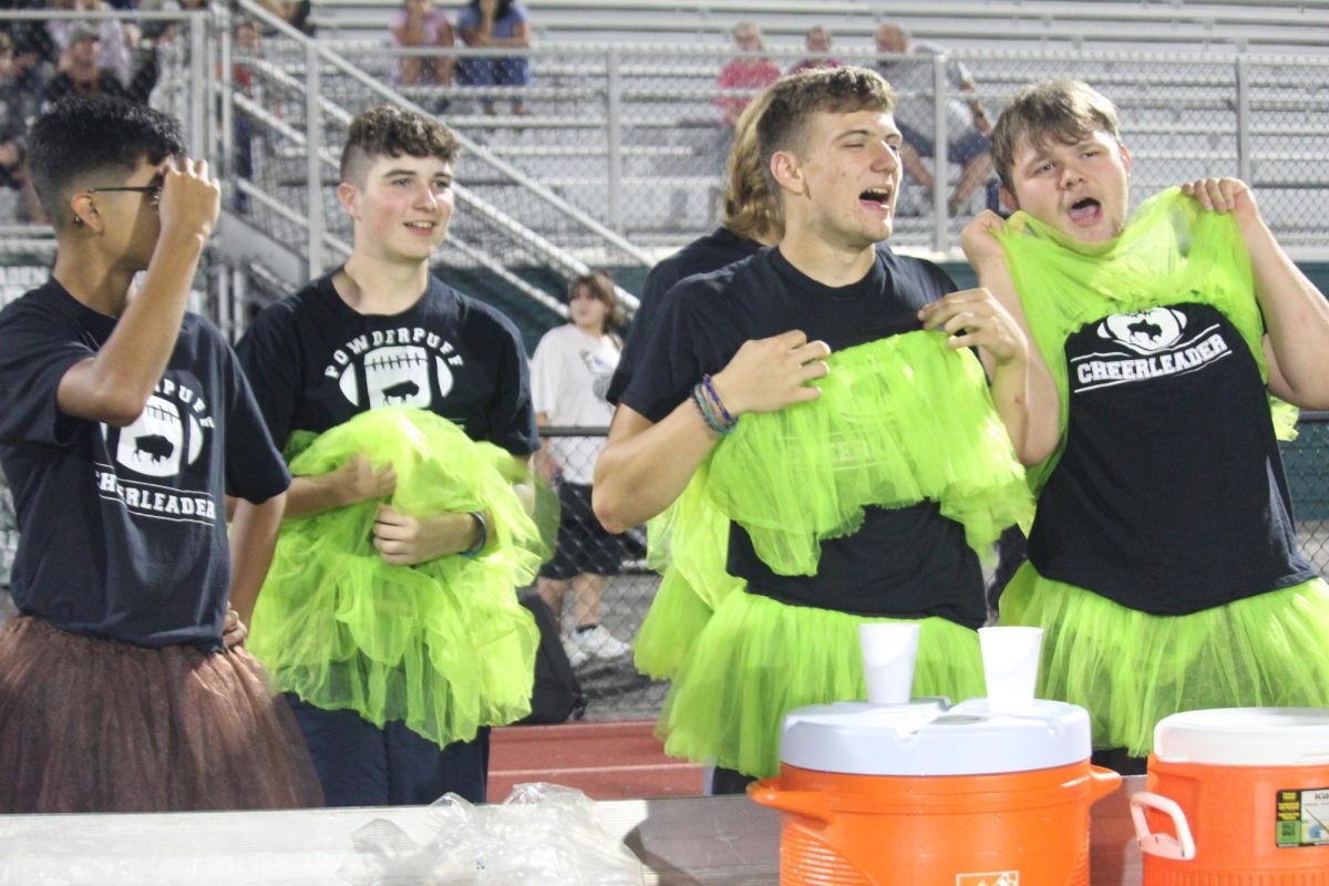 JUNIOR JOY: Junior cheerleaders layer their bright green tutu's in support of their girl's football team.
