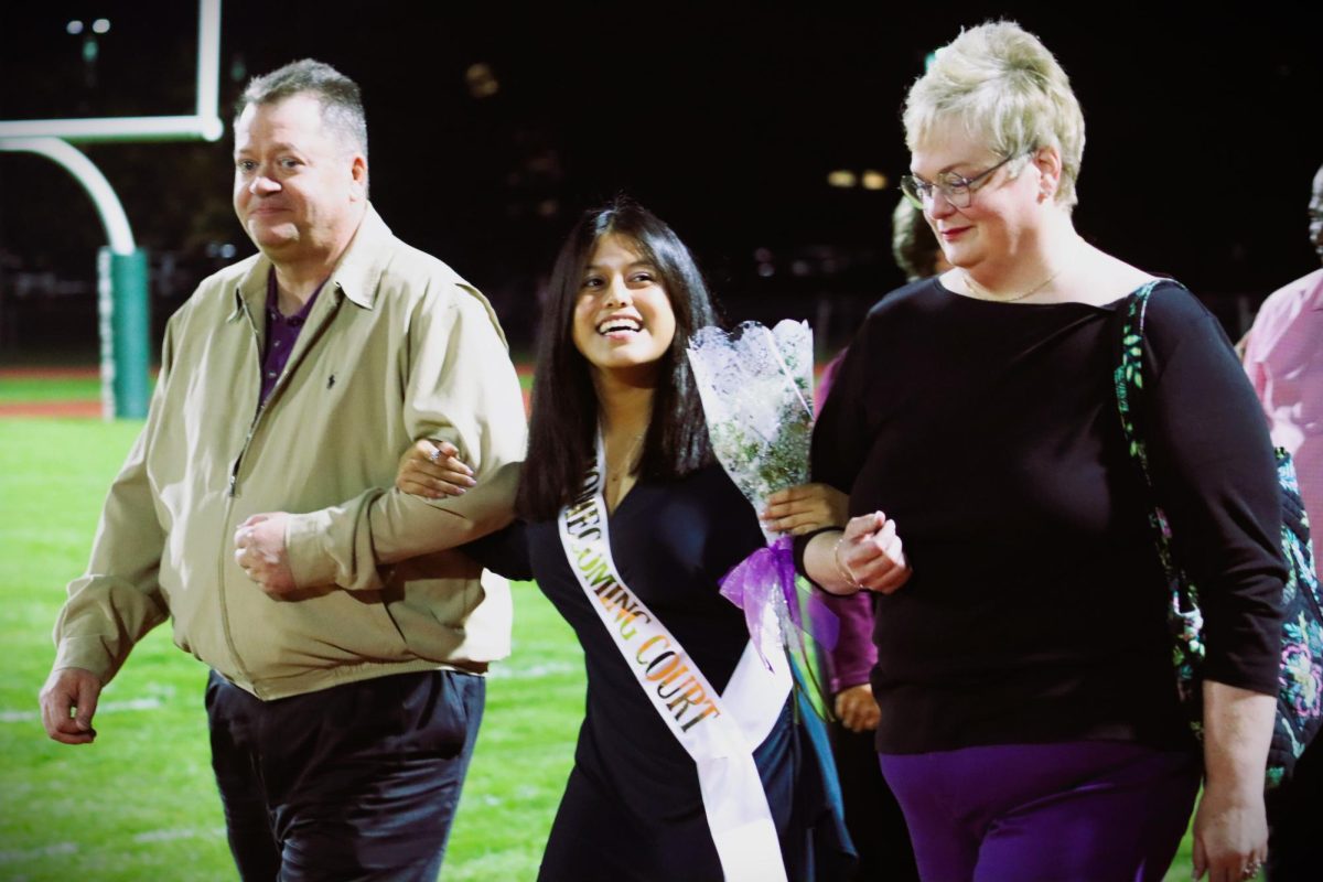 Bella Koontz escorted by her parents.