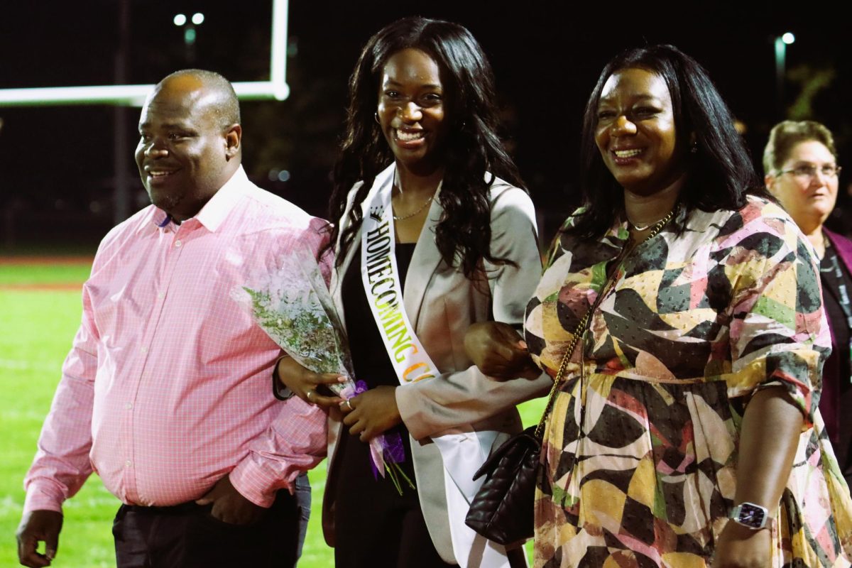 Camryn Nelson escorted by her parents.