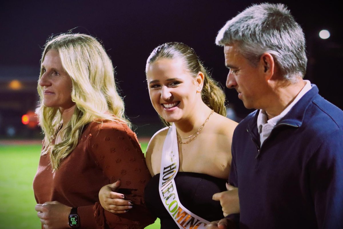 Jillian Witman escorted by her parents.