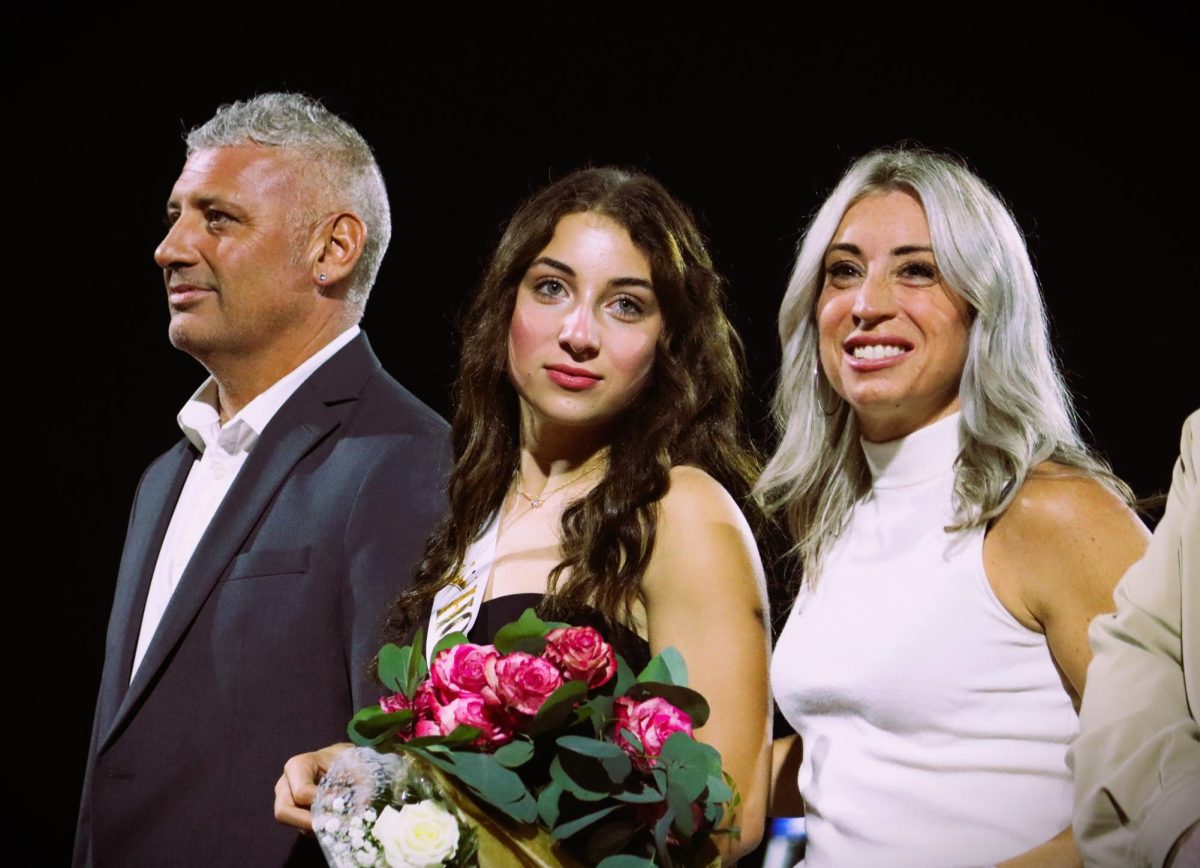 Maia Iannuzzi escorted by her parents.