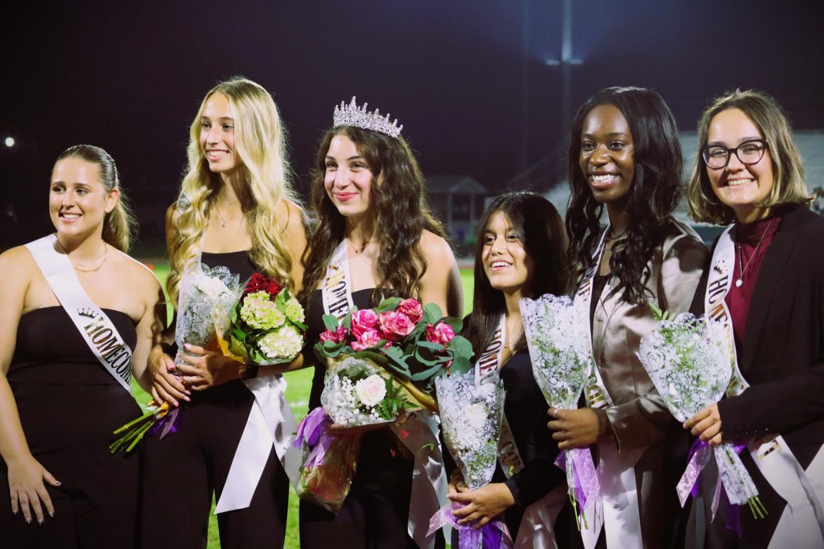 FLOWERS FOR ALL: All six hoco-court nominees pose with bouquets of flowers and smiles.