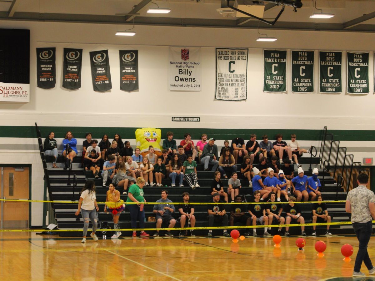 ON THE EDGE: Half of the crowd sits in anticipation after the excitement of a round.