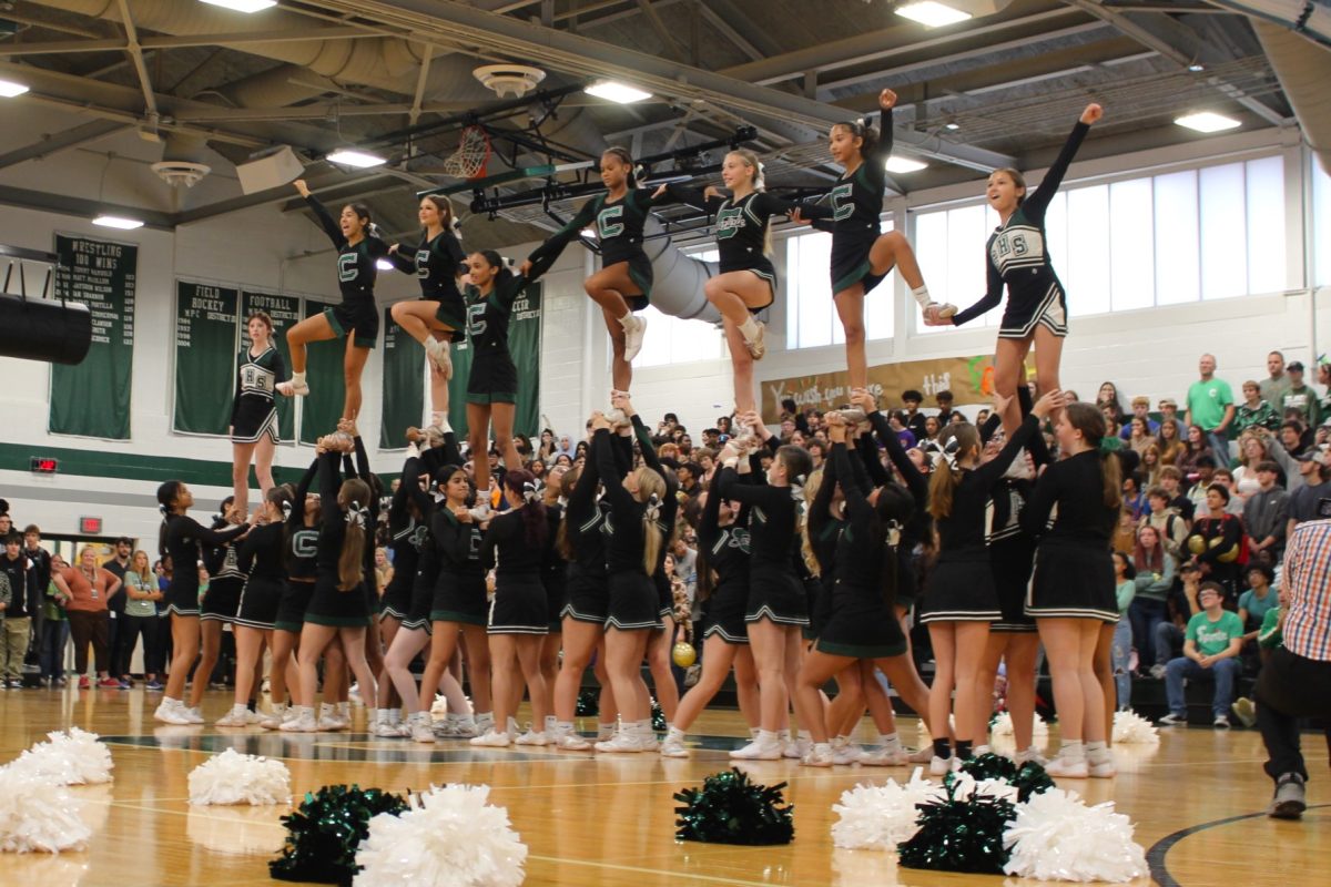 CHEER PYRAMID: Both the Junior Varsity and Varsity Cheer squads collaborated to form one huge pyramid of school spirit!