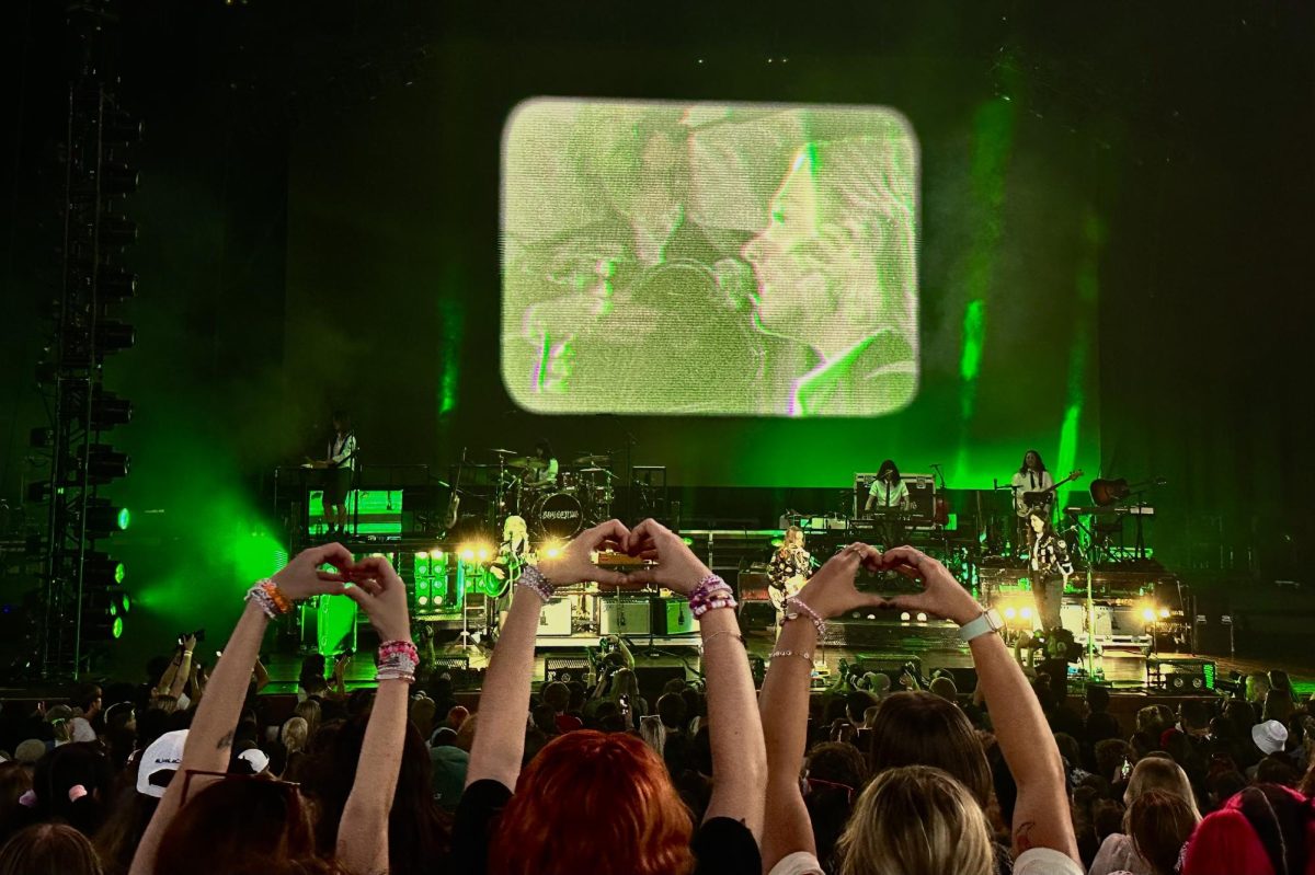 HEART-HANDS: Concert goers show boygenius their admiration through a perfectly synced heart-hand gesture. Boygenius at the All Things Go fesival performing Emily Im Sorry off their debut album. 