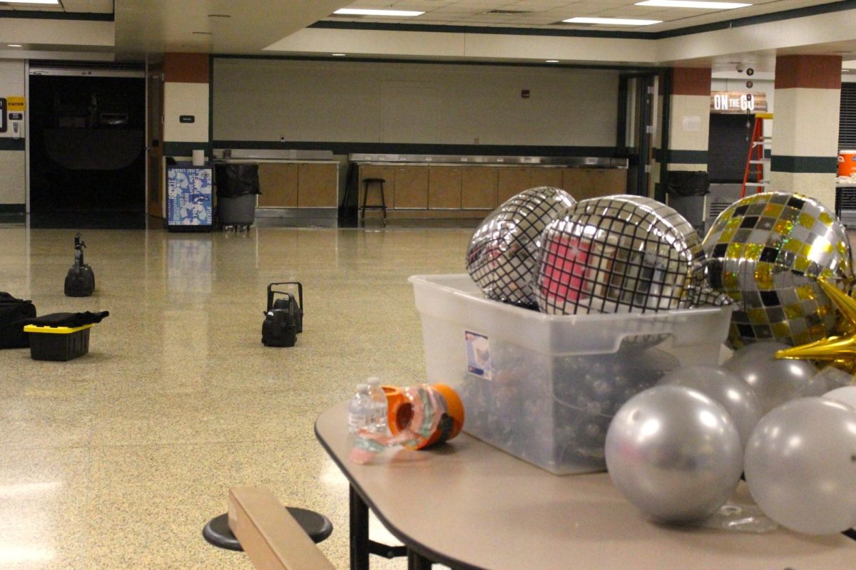 CALM BEFORE THE STORM: Bins of metallic discoball balloons wait to be hung up in the cafeteria. 