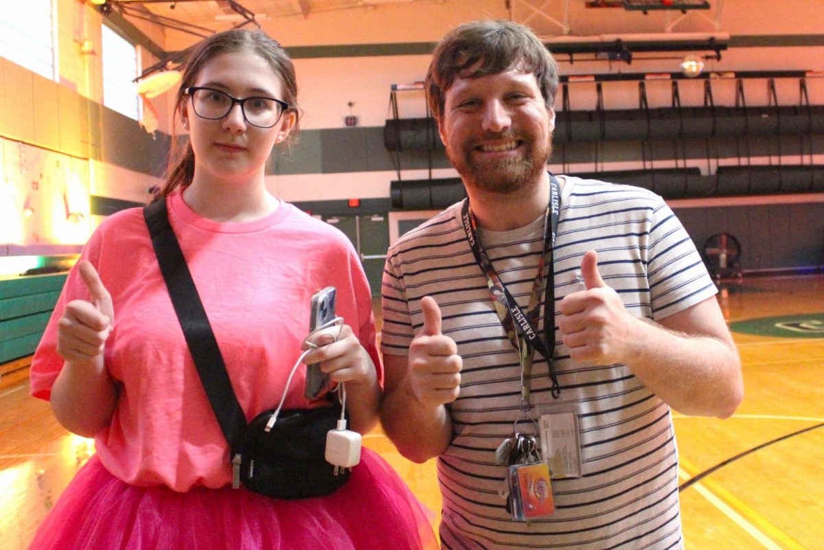 THUMBS UP: Cordelia Thomas and Mr. Smith are excited to be done setting up the gym for the dance!