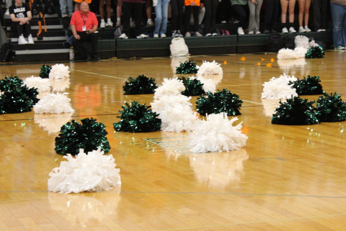 POM-POMS & PEP: The Cheerleaders pom-poms lay on the floor of the gym as they come together to perform a routine for the pep-rally!