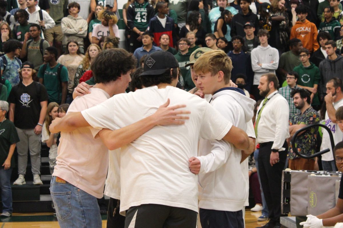 HUDDLE UP: The student dodgeball team, "The Cupcakes", huddle together to devise a strategy against the teacher-team in the final round of dodgeball. "The Cupcakes" (Logan Peterson, Cohan Bailey, Nick Friscia, Marcus Barnett, and Darian Crim) won the student bracket on Monday and fell to the teacher-team on Friday with help from Dylan Bonner, who was substituting for Marcus Barnett. 