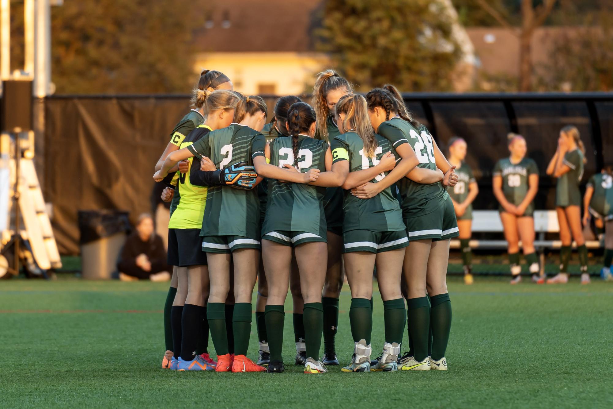 TEAMWORK: The girls varsity soccer players gather to discuss their plays in hope for a win.