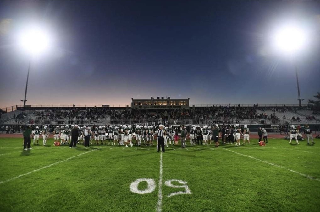 FNL: The stadium lights shine over the football team as they get ready to take on their game.