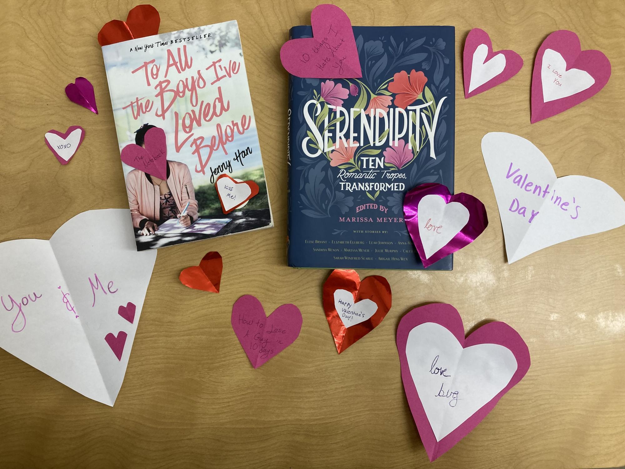 FALLING FOR YOU: To All the Boys Ive Loved Before and Serendipity sit side-by-side amongst heart-shaped Valentines. A couple of the hearts feature the names of movies listed in the article. 