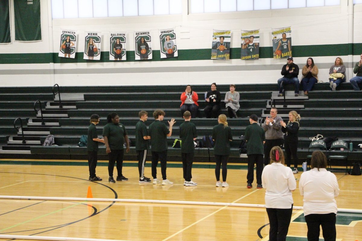 ANNOUNCEMENT: The Carlisle bocce ball team waits for their name to be announced at the beginning of their match.