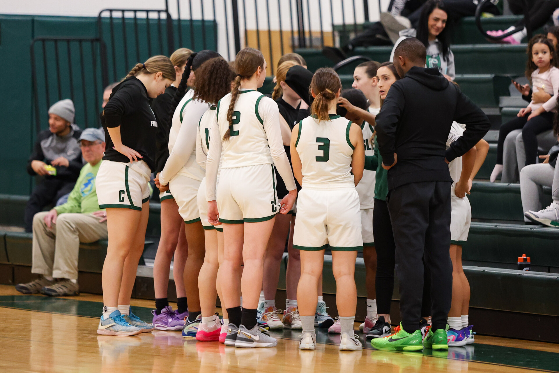 HUDDLE UP: The girls discuss their game plans before their game begins.