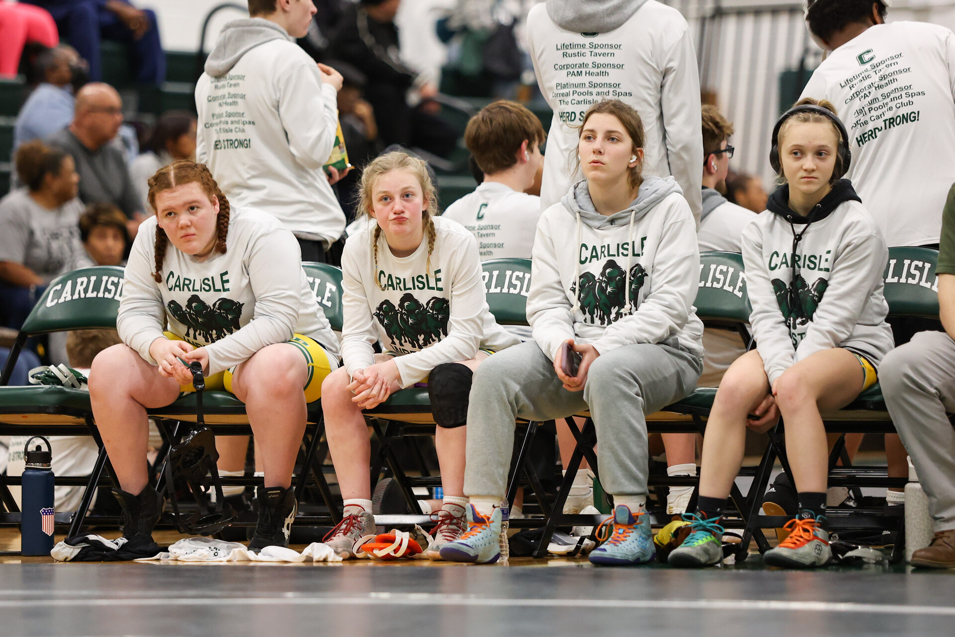 FOCUS: The girls wrestling team focuses as they wait for their time to shine on the mat.