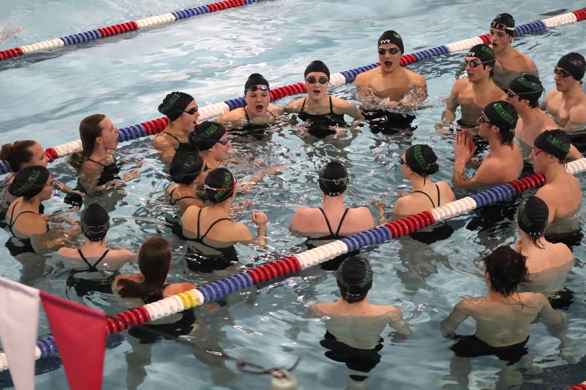 GIVE ME A C: Carlisle Swim team huddles in the pool before a home meet at Dickinson.