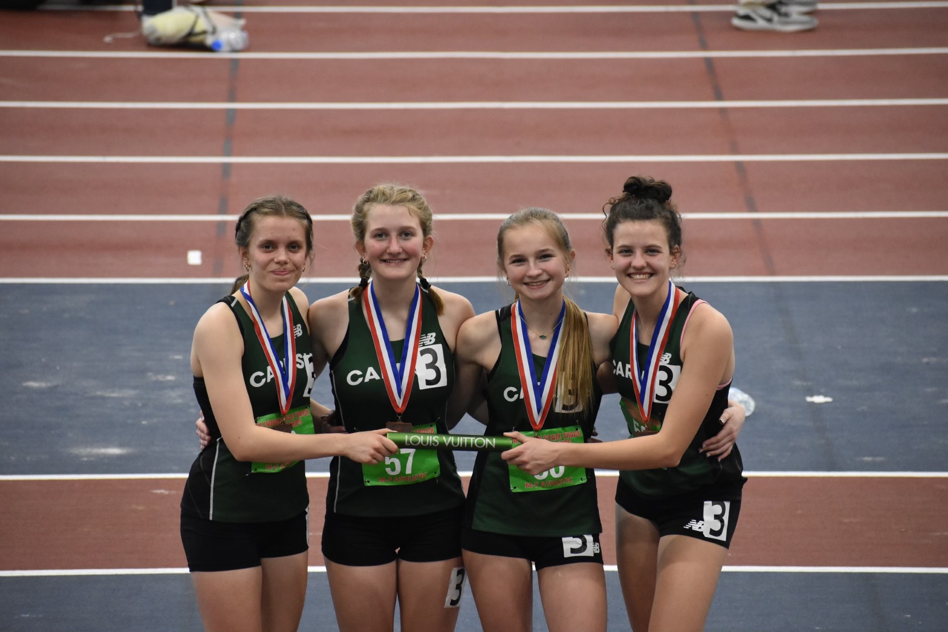 CHAMPIONS: (Left to right) Ana Bondy, Elisabeth Bordner, Savannah Oakes, and Emily Leatherman smile after placing 3rd at state championships.