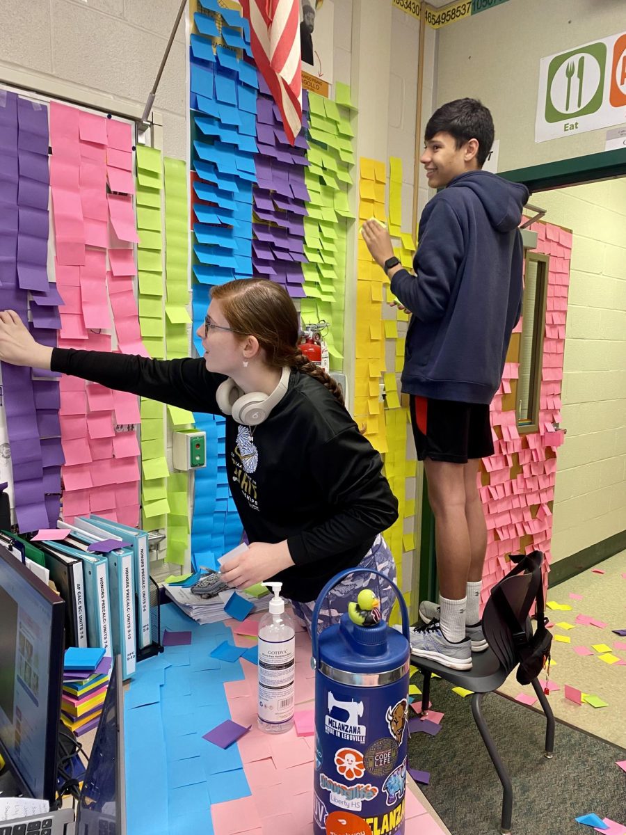 Mark Intini and Morgan Hopper, work together to make the math room feel like walking inside a pinata. 