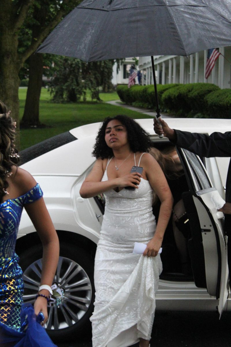 Limo pulls up with multiple students inside.